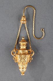 Gold perfume flask amphora bottle with a chain. 