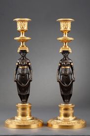 An early pair of ormolu and patinated bronze candelsticks. 