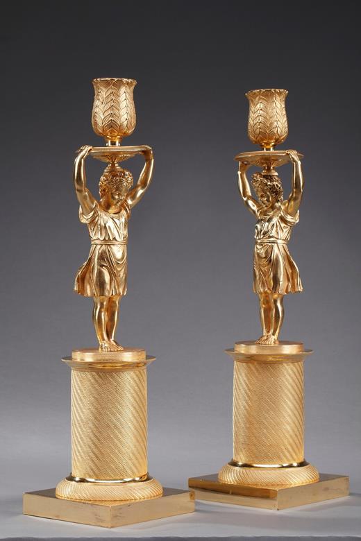 pair of gilt bronze candelsticks representing a girl and a boy  restoration period