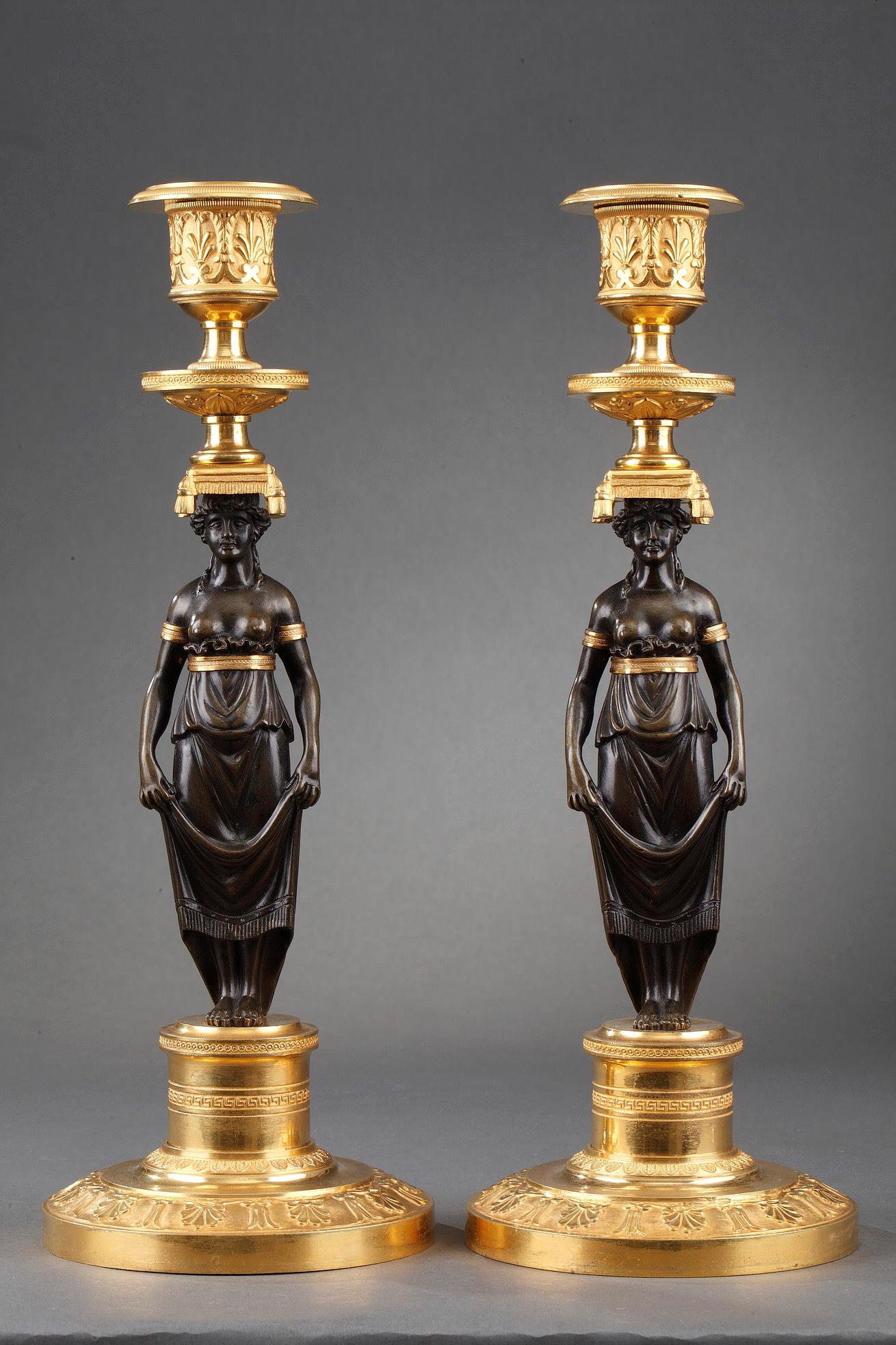 An early pair of ormolu and patinated bronze candelsticks. 