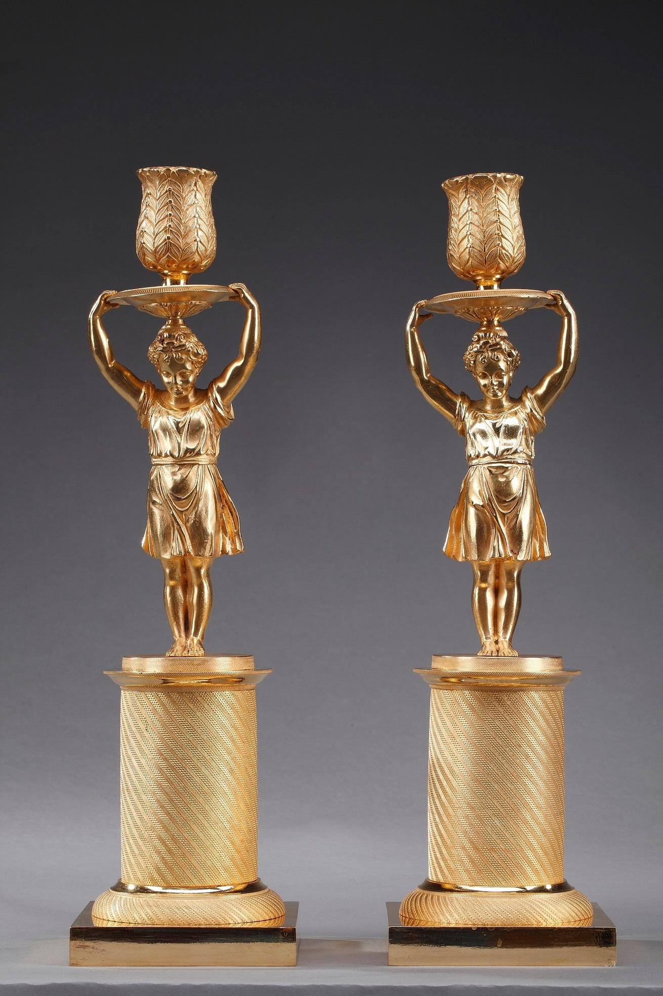 pair of gilt bronze candelsticks representing a girl and a boy  restoration period